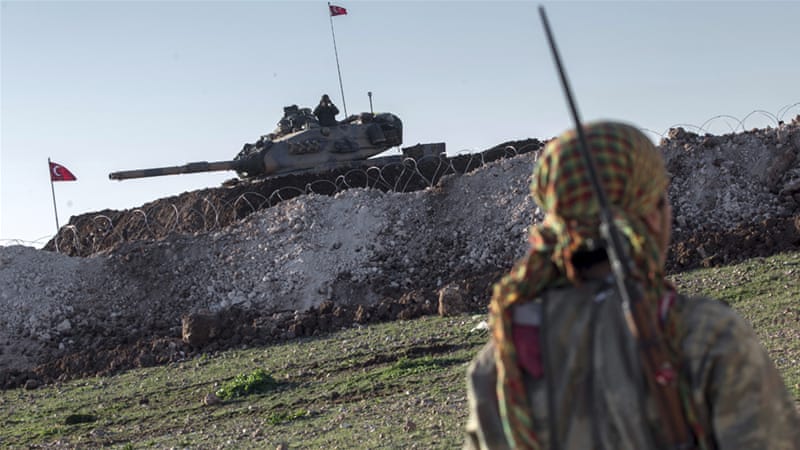 A Kurdish YPG fighter patrols near a Turkish tank in Esme village in Syria_s Aleppo province in 2015_Mursel Coban_Depo Photos _AP