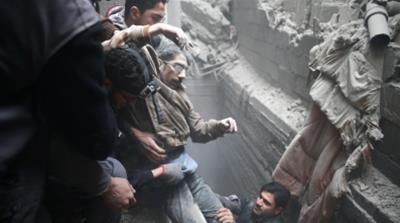 Civil defence help a man from a shelter in the besieged town of Douma in Eastern Ghouta_Bassam Khabieh_Reuters