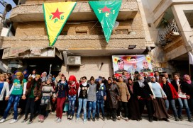 Kurdish civilians perform traditional dance as they celebrate, reports of Kurdish forces taking control of Syrian town of Kobani, in Sheikh Maksoud neighborhood of Aleppo