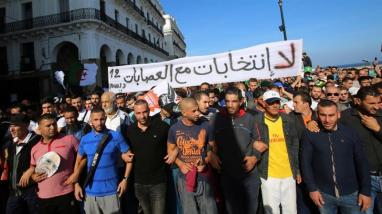 Demonstrators carry a banner that reads 'no elections with the gangs' during a protest against the country's ruling elite _Ramzi Boudina_Reuters